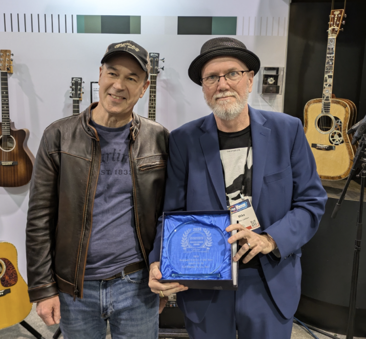 Thomas Ripsam, CEO/President, C.F. Martin & Co. receives the Dealers' Choice Award for 2024 Acoustic Guitar of the Year from MMR publisher Mike Lawson